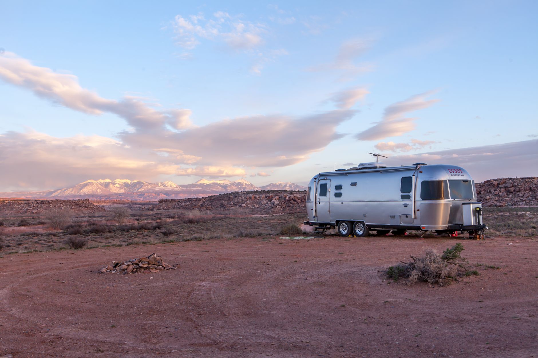Vintage Airstream trailer parked in the desert at dusk